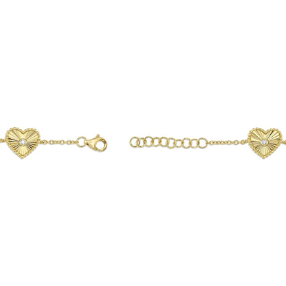 0.10CT 14K Y/G DIAMOND BEZEL RIBBED HEART BRACELET