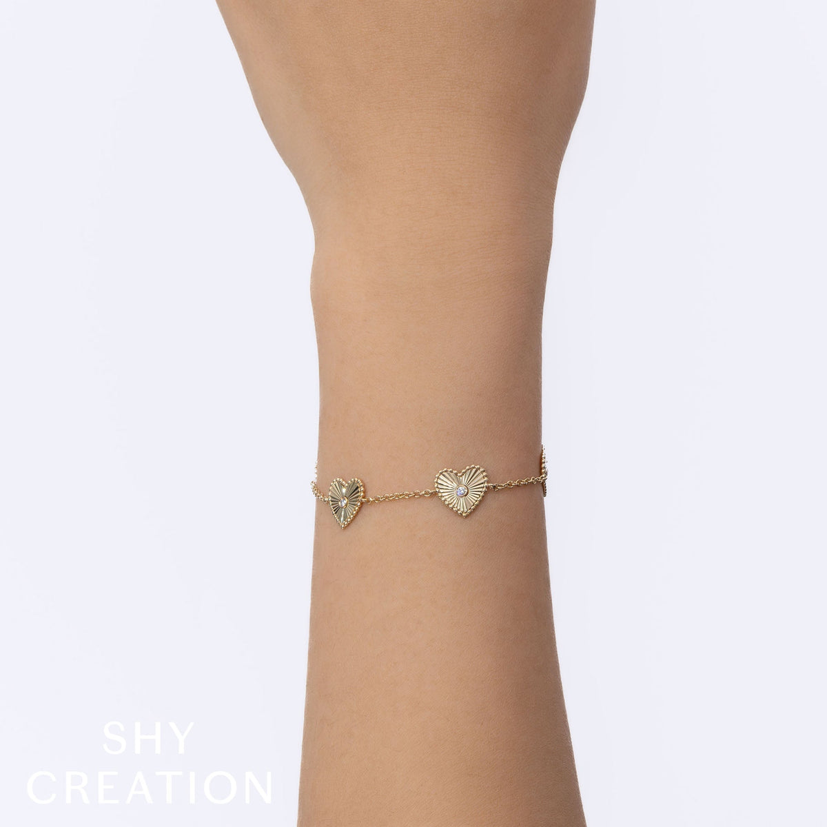 0.10CT 14K Y/G DIAMOND BEZEL RIBBED HEART BRACELET